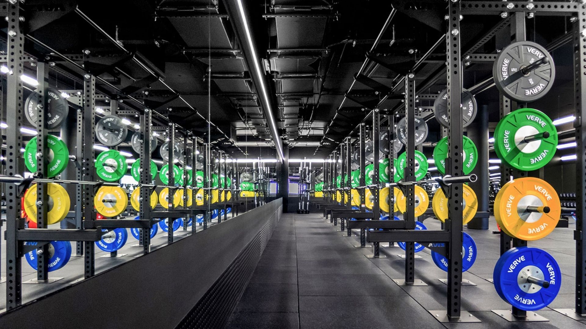 Mirrored lifting corridor with racked barbells