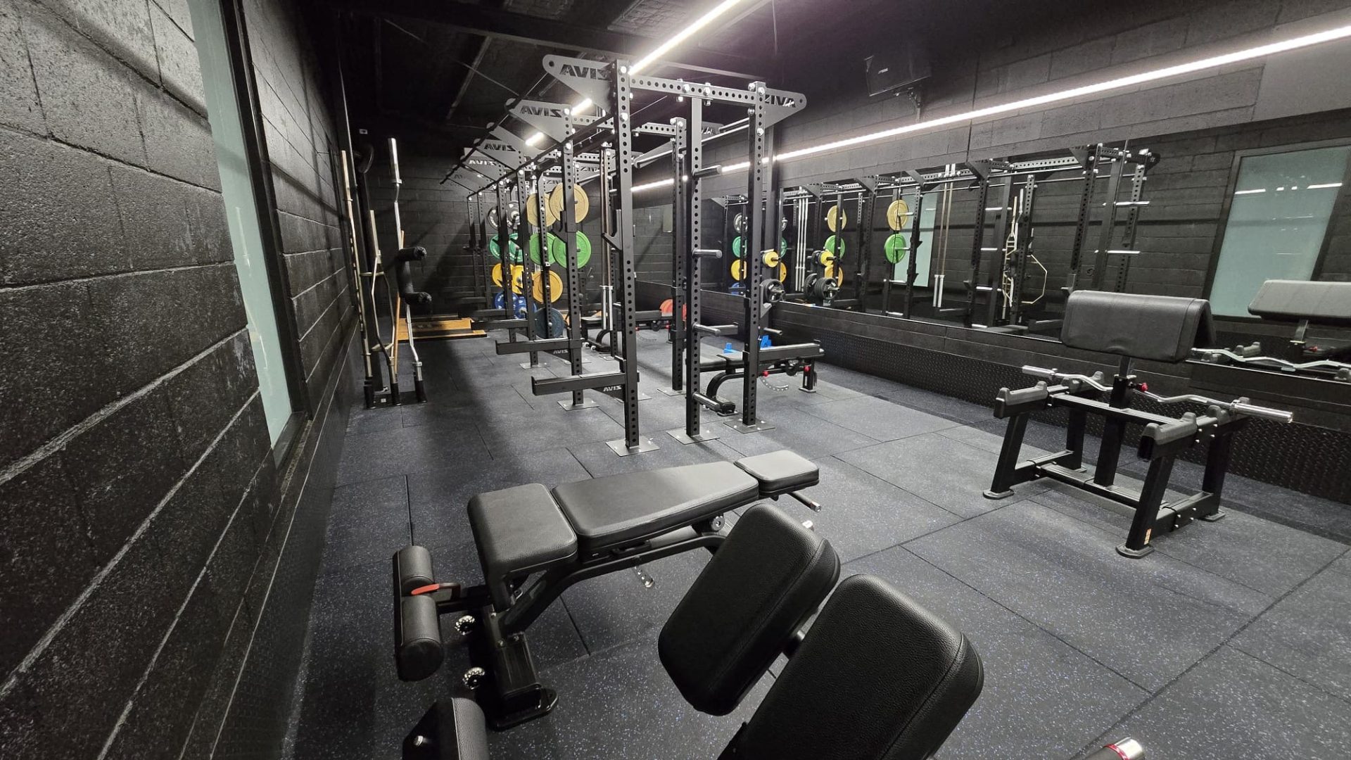 Benches and racks along the mirrored wall